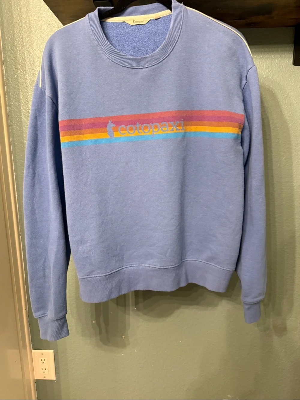 cotopaxi blue crewneck sweater with multicolor stripe logo